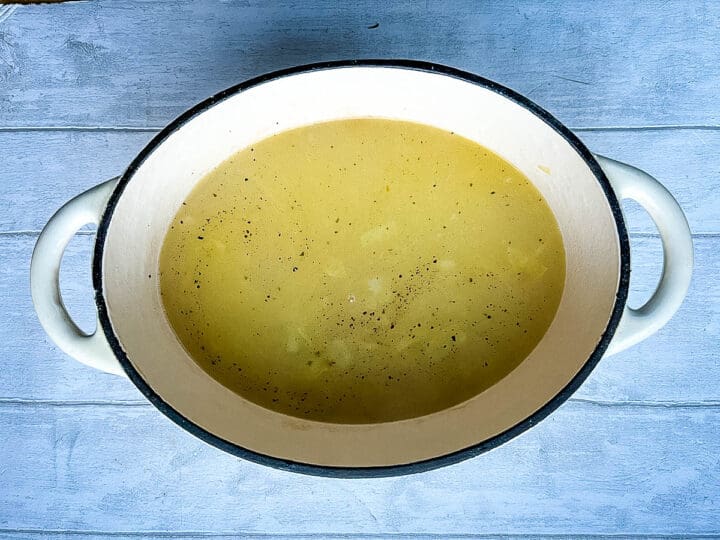 stock added to rice in pan