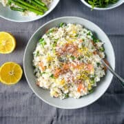smoked salmon risotto finished dish with lemon zest and grated parmesan cheese