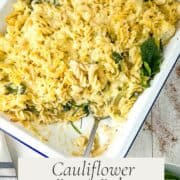 pinterest image for cauliflower pasta bake recipe with finished dish served with a side of spinach