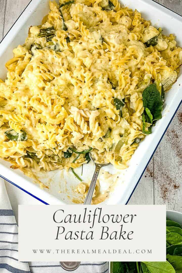 pinterest image for cauliflower pasta bake recipe with finished dish served with a side of spinach