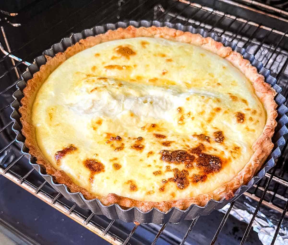 partially cooked cheese flan in oven