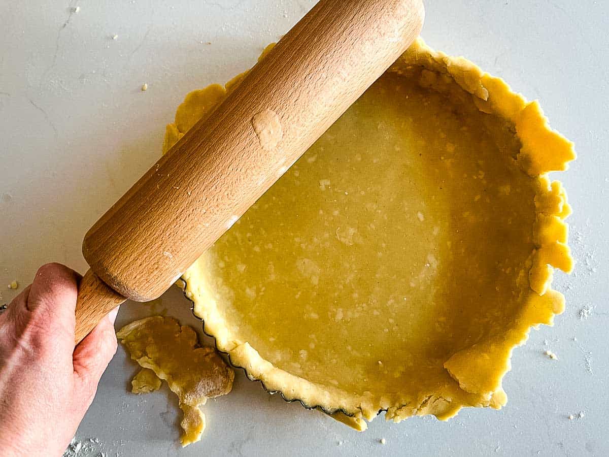 pastry in flan dish trimmed with rolling pin