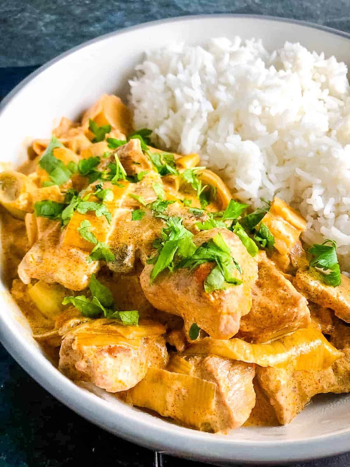 leftover pork stroganoff topped with fresh parsley and served with rice.