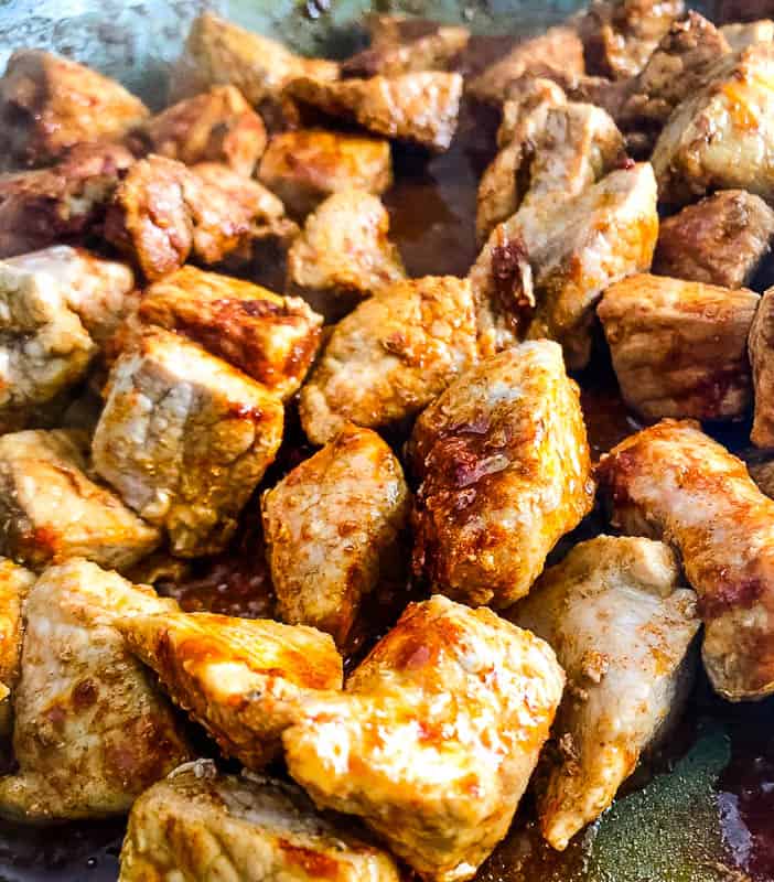 pork and paprika frying in pan.