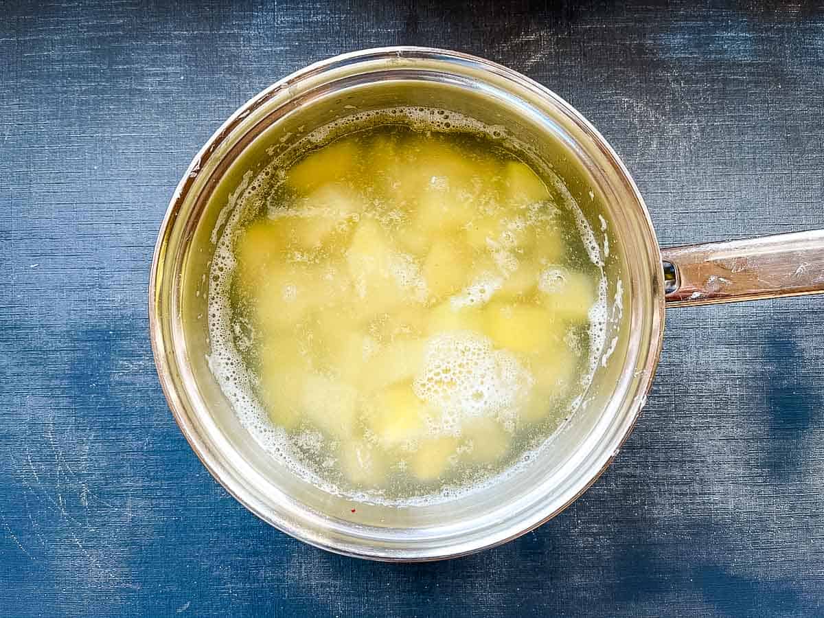potatoes simmering in a pan.
