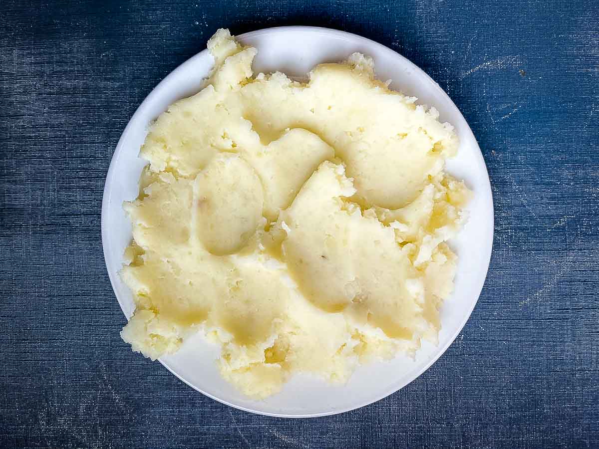 mashed potato spread on plate to cool.