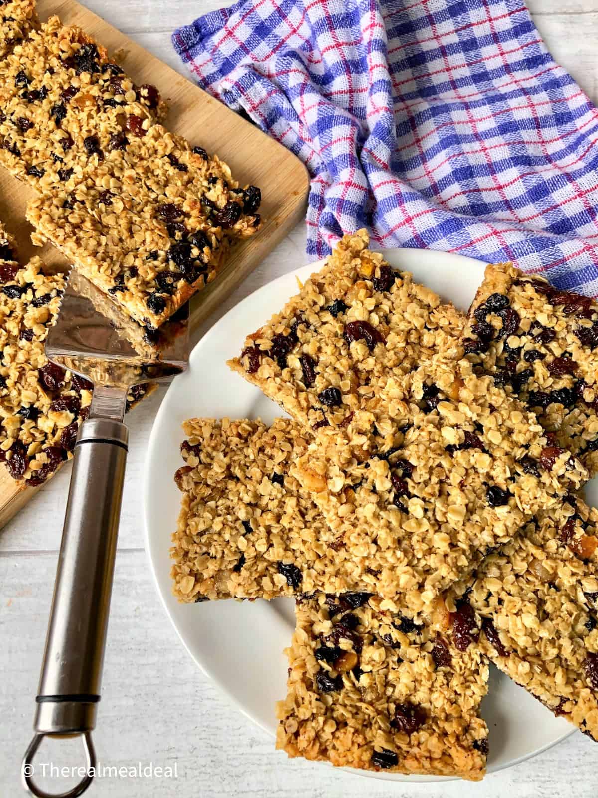 fruit flapjacks cut into squares on plate.