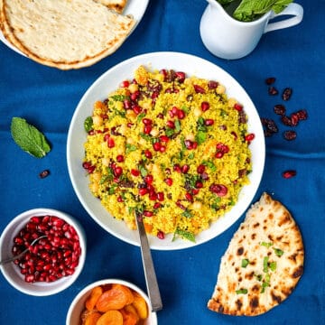 couscous in a bowl served with pomegranate seeds