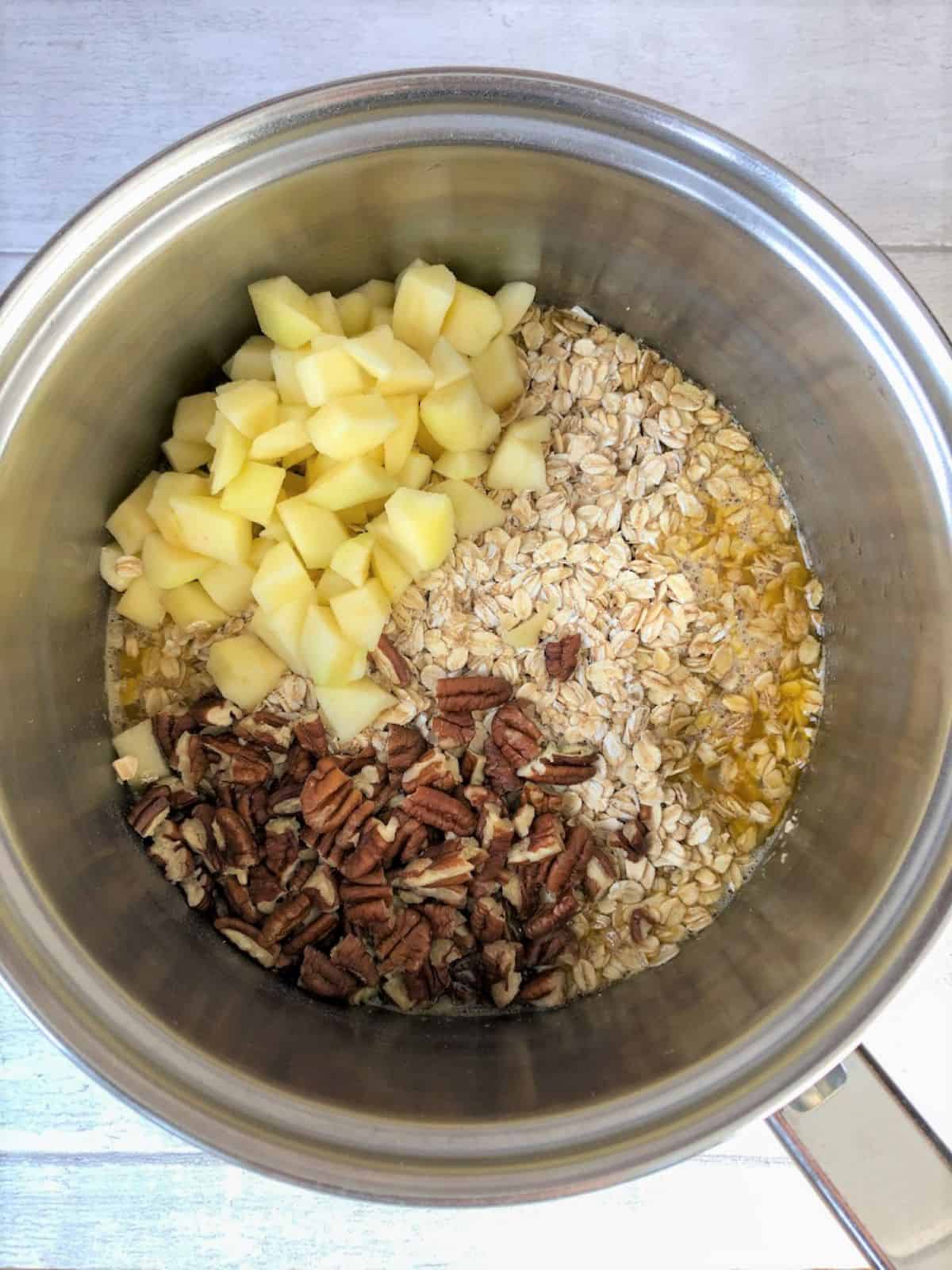 diced apple, peacan nuts, rolled oats added to butter and syrup in pan