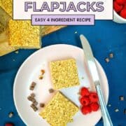 sliced banana flapjacks on plate with raspberries