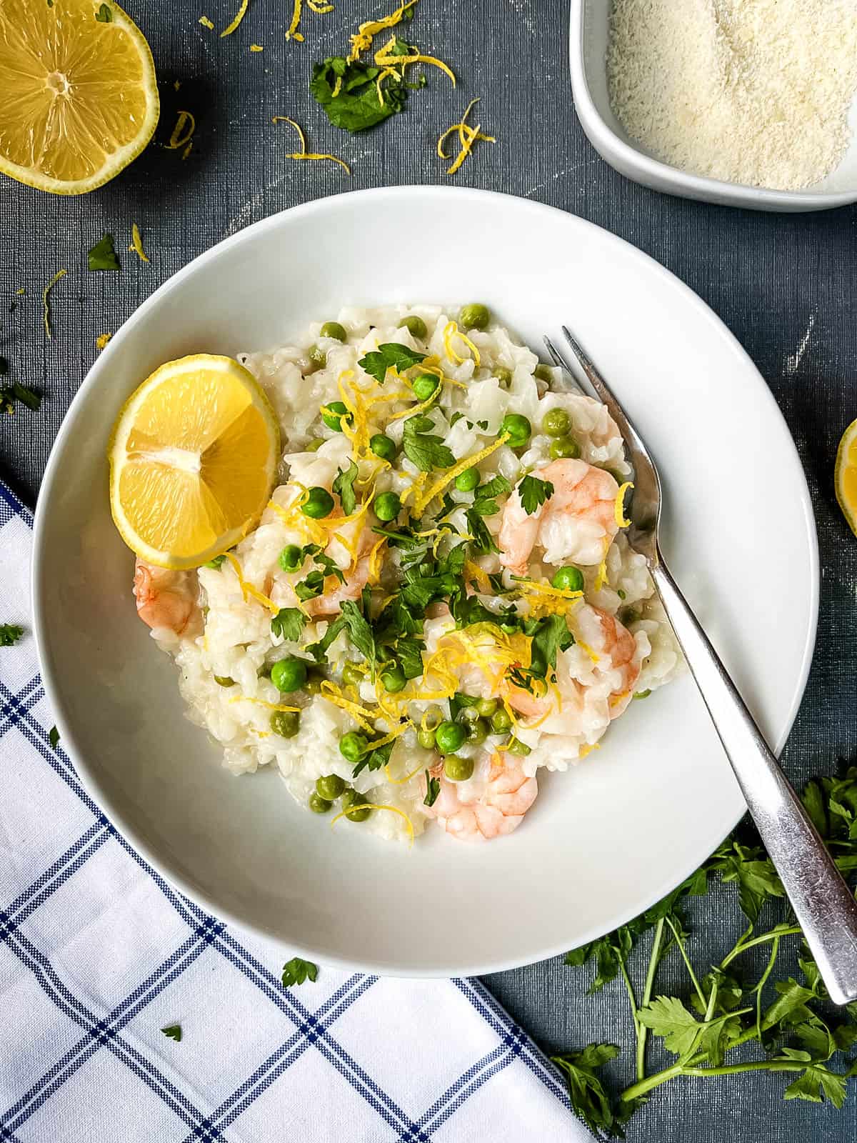 prawn and pea risotto with lemon zest in a bowl.