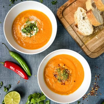 bowls of sweet potato soup topped with ime zest and crushed chilli flakes.