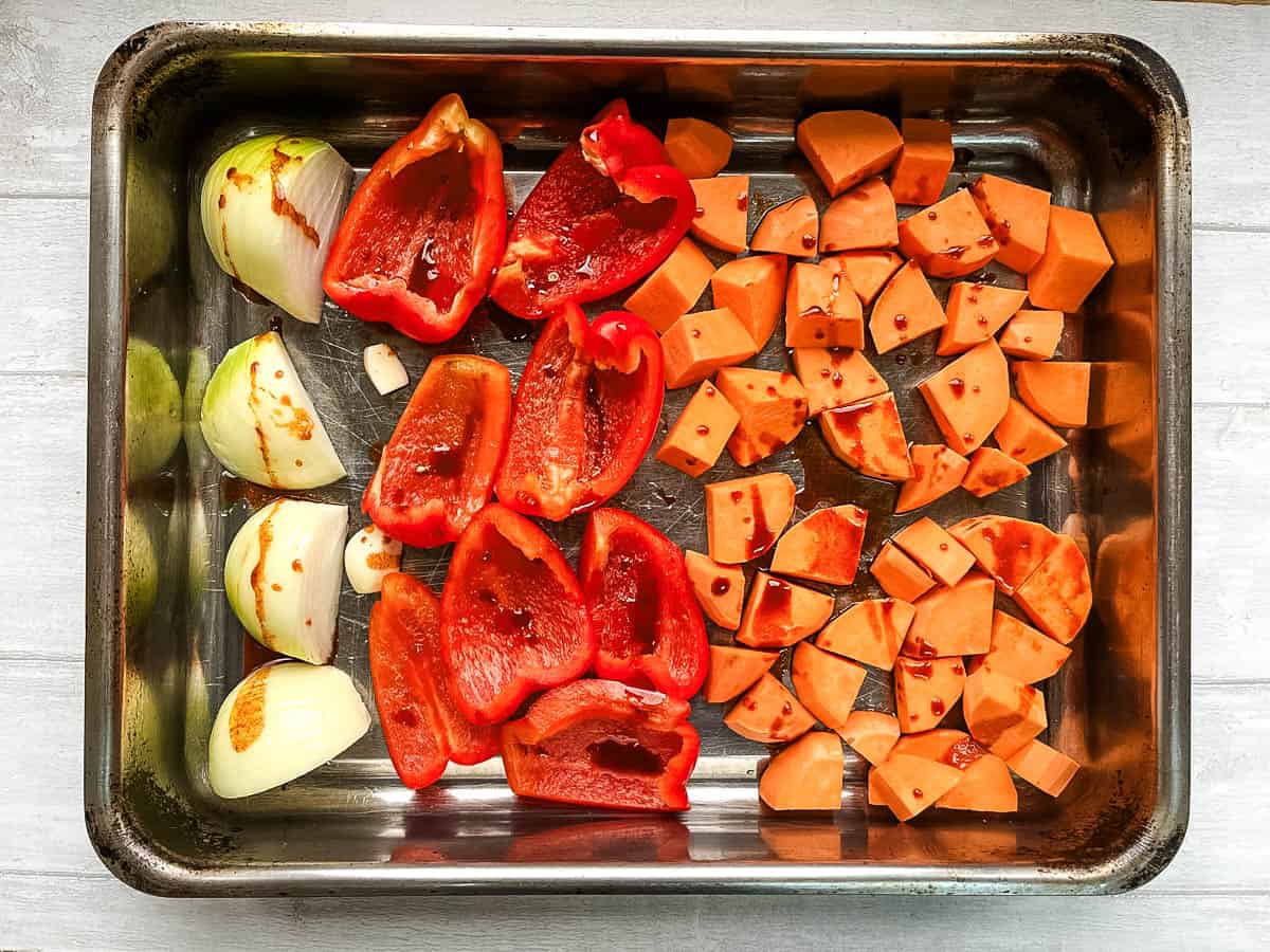diced vegetables ready for roasting drizzled with olive oil and smoked paprika.