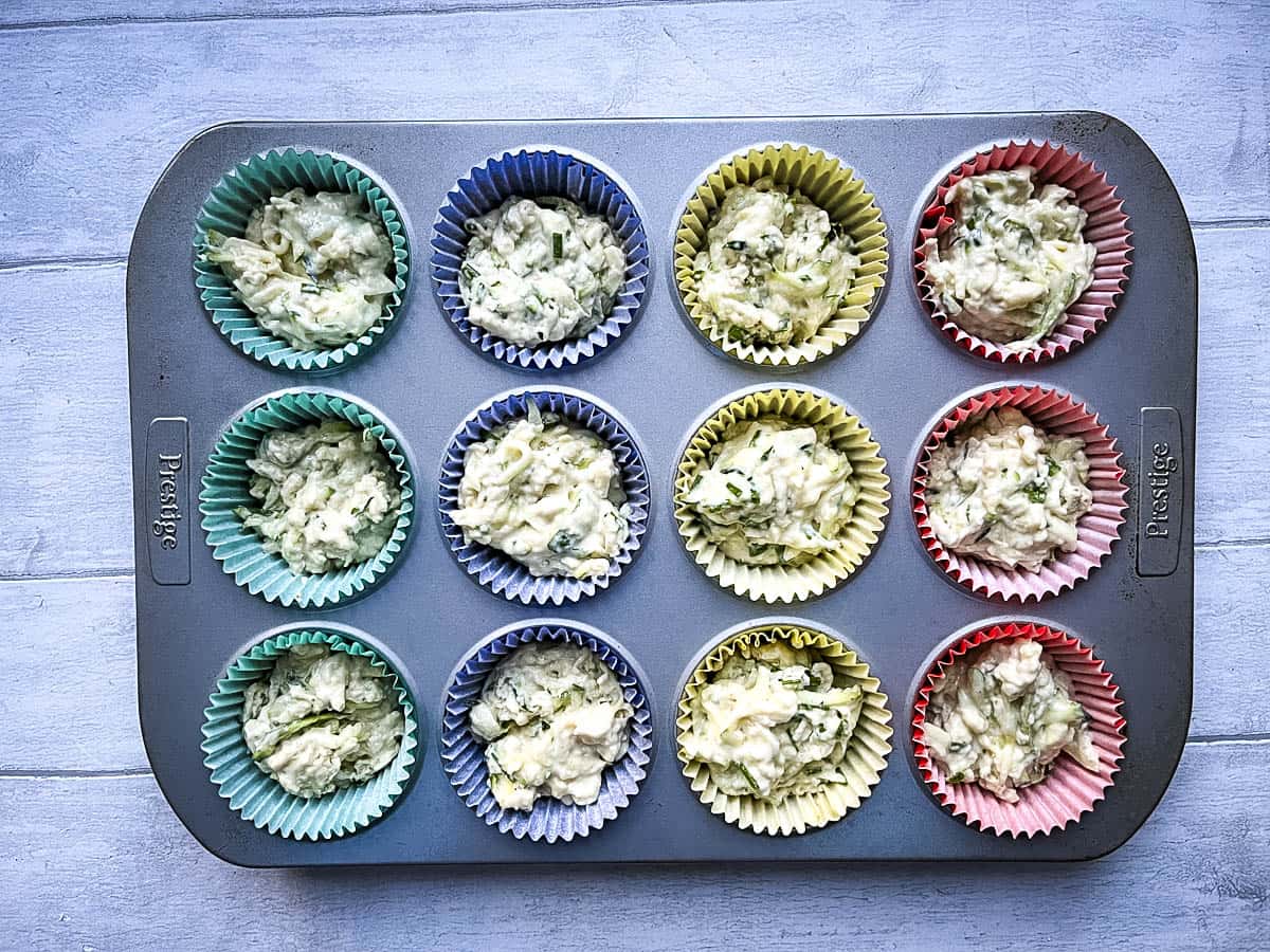 cheese and courgette muffins in cases ready for oven.