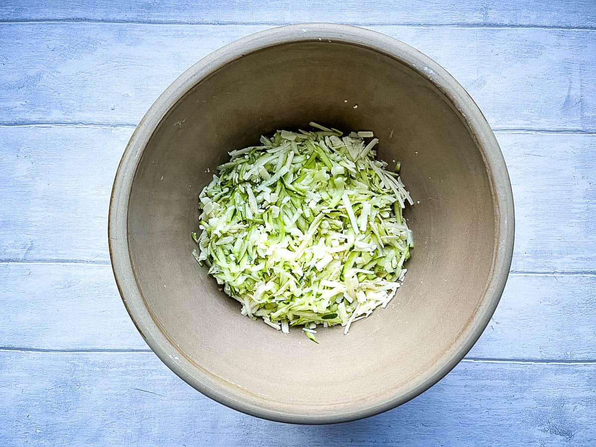 grated courgette /zucchini and cheddar cheese in a bowl