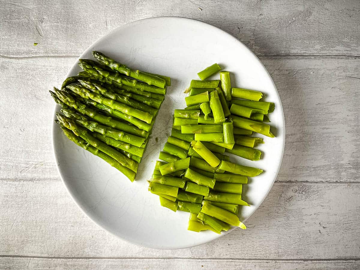 chopped asparagus stems on plate.