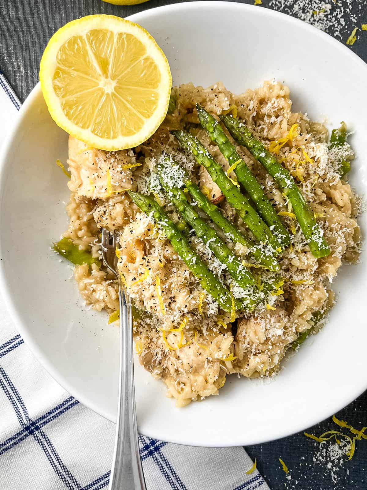 chicken and asparagus risotto served with lemon.