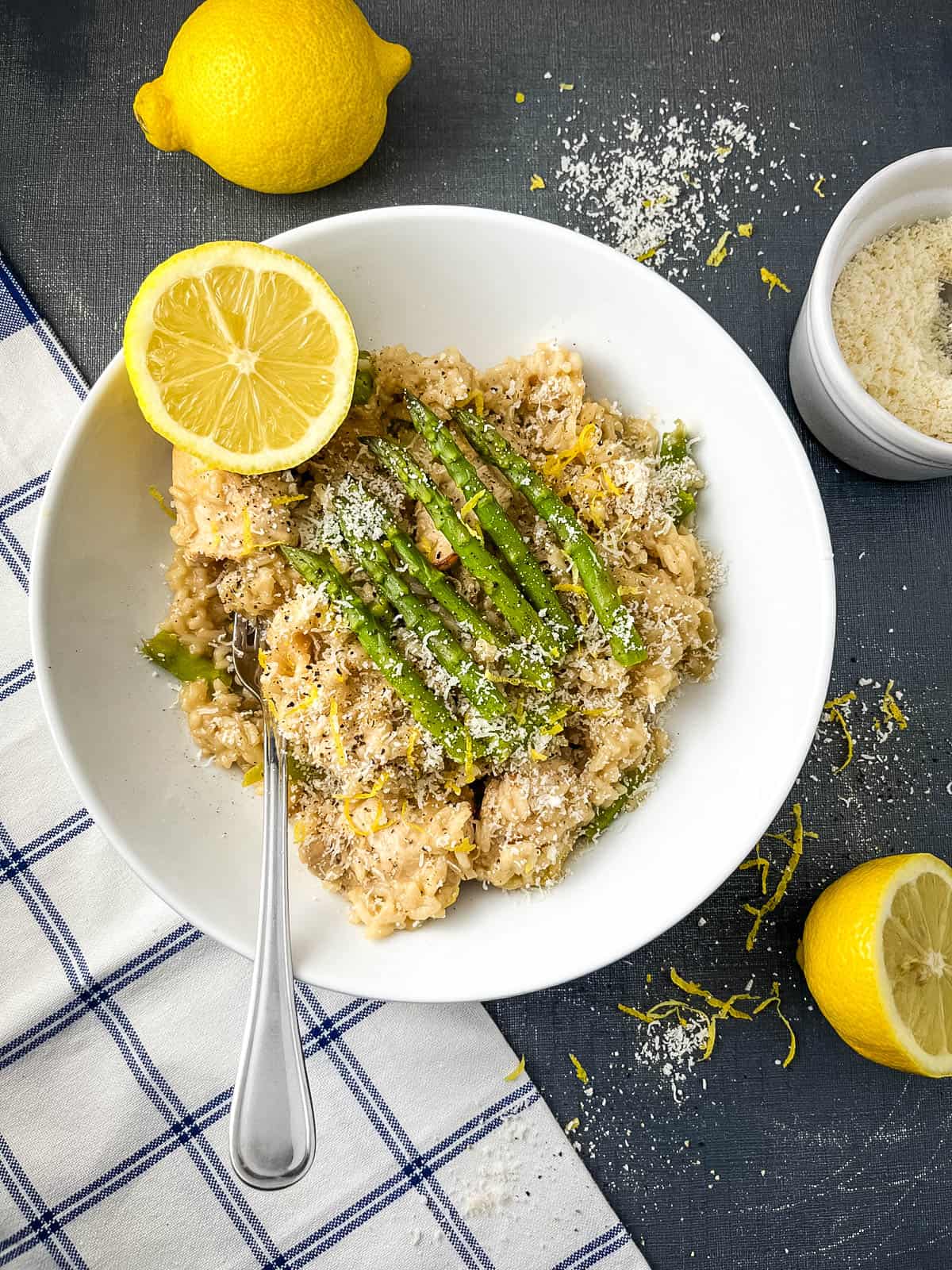 asparagus and chicken risotto served with lemon in a bowl.