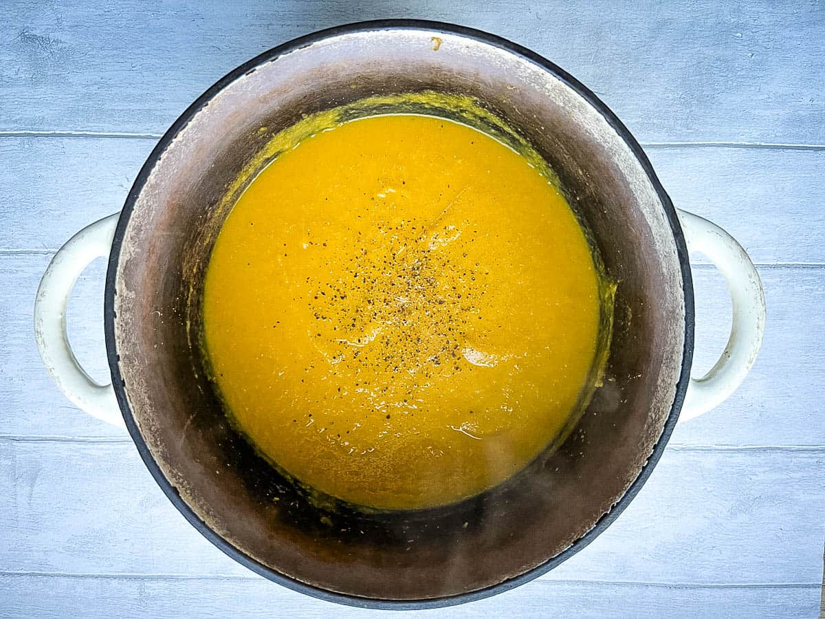 carrot and cumin soup blended in pan