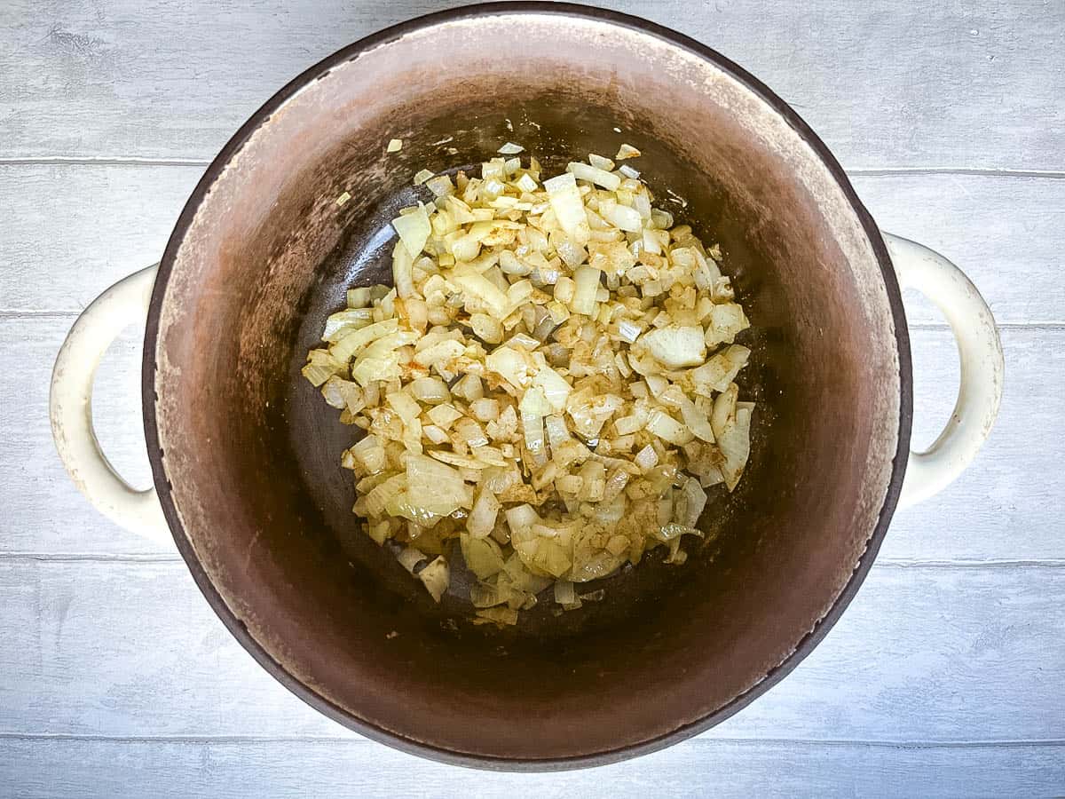 onions frying in pan with cumin