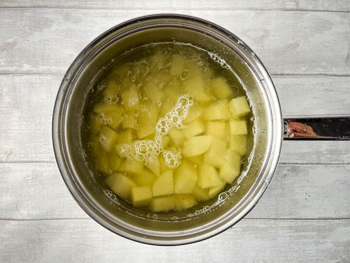 diced potatoes simmering in pan.