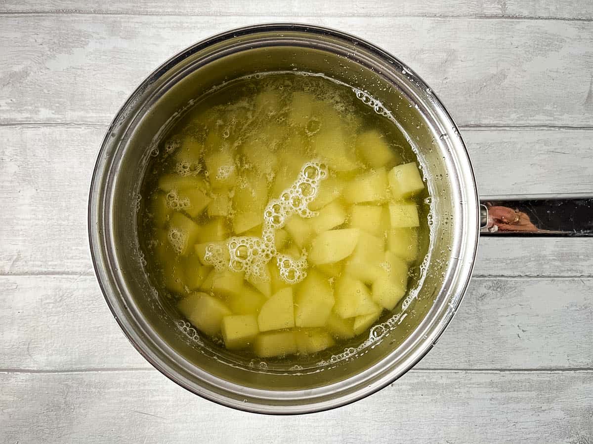 diced potatoes simmering in pan.