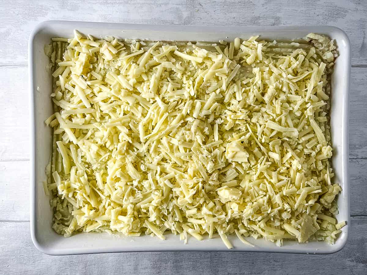 vegetarian cottage pie topped with mashed potato and grated or shredded cheese.