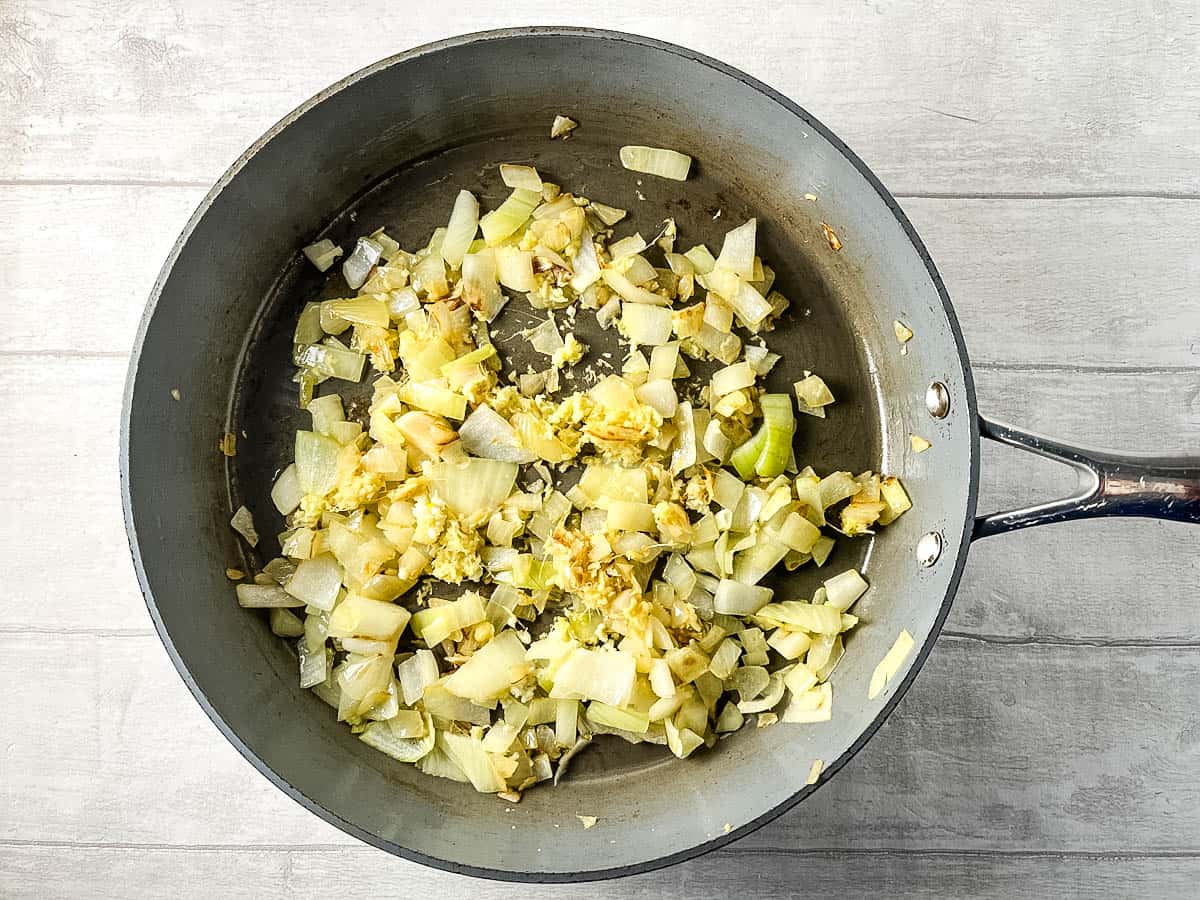 diced onions, ginger and garlic frying in pan.
