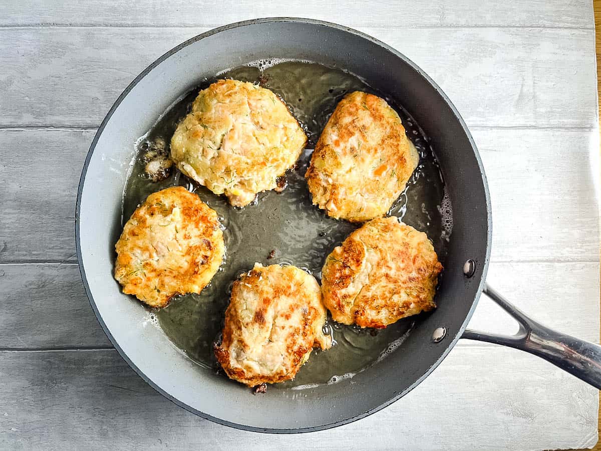 salmon fishcakes in a frying pan
