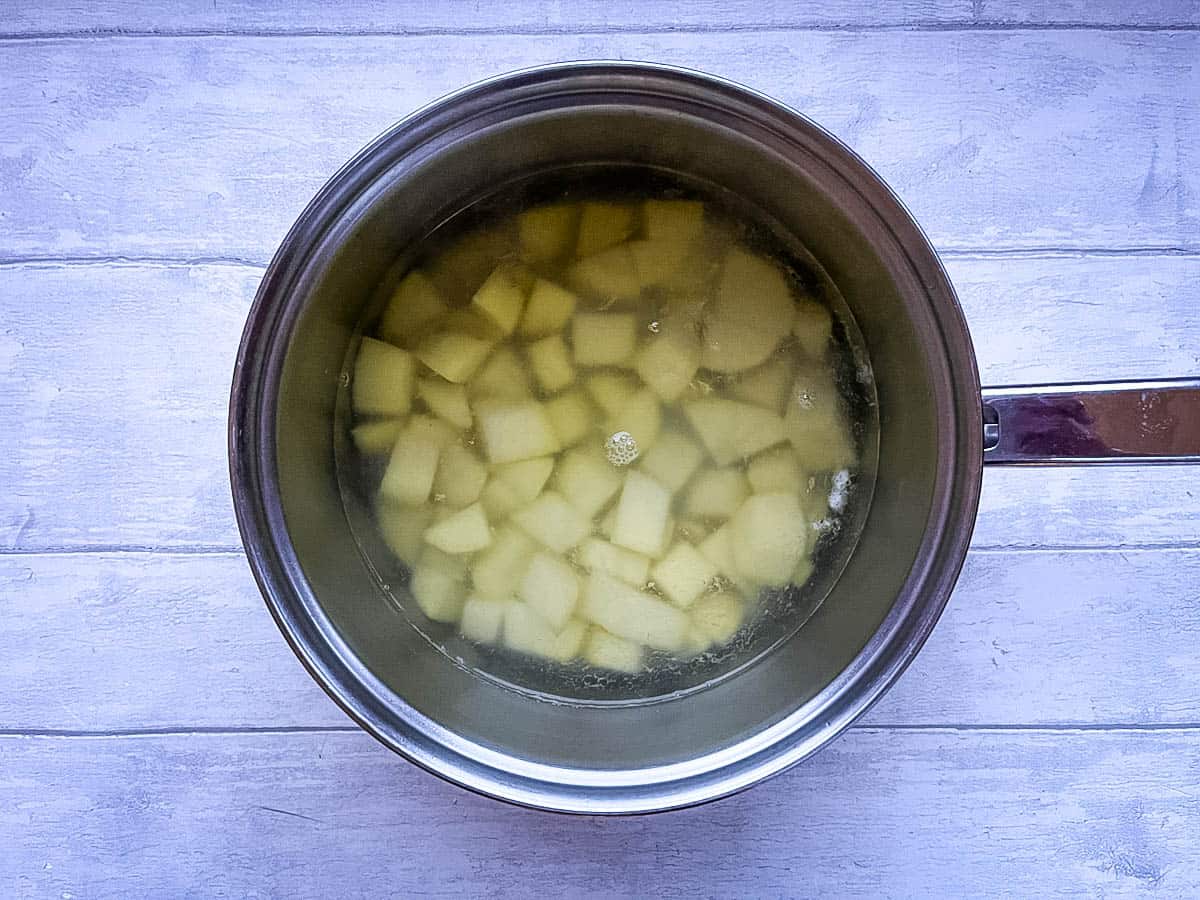 diced potato simmering in a pan.