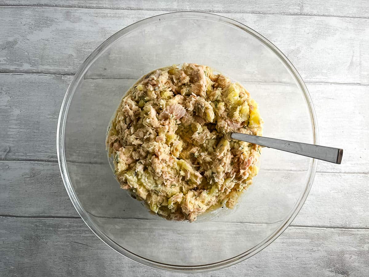 salmon potato egg flour dill lemon juice mixed together in a bowl.