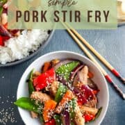 pork stir fry topped with sesame seeds in a bowl.