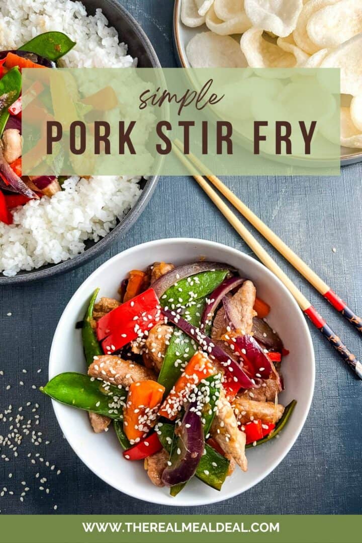 pork stir fry topped with sesame seeds in a bowl.