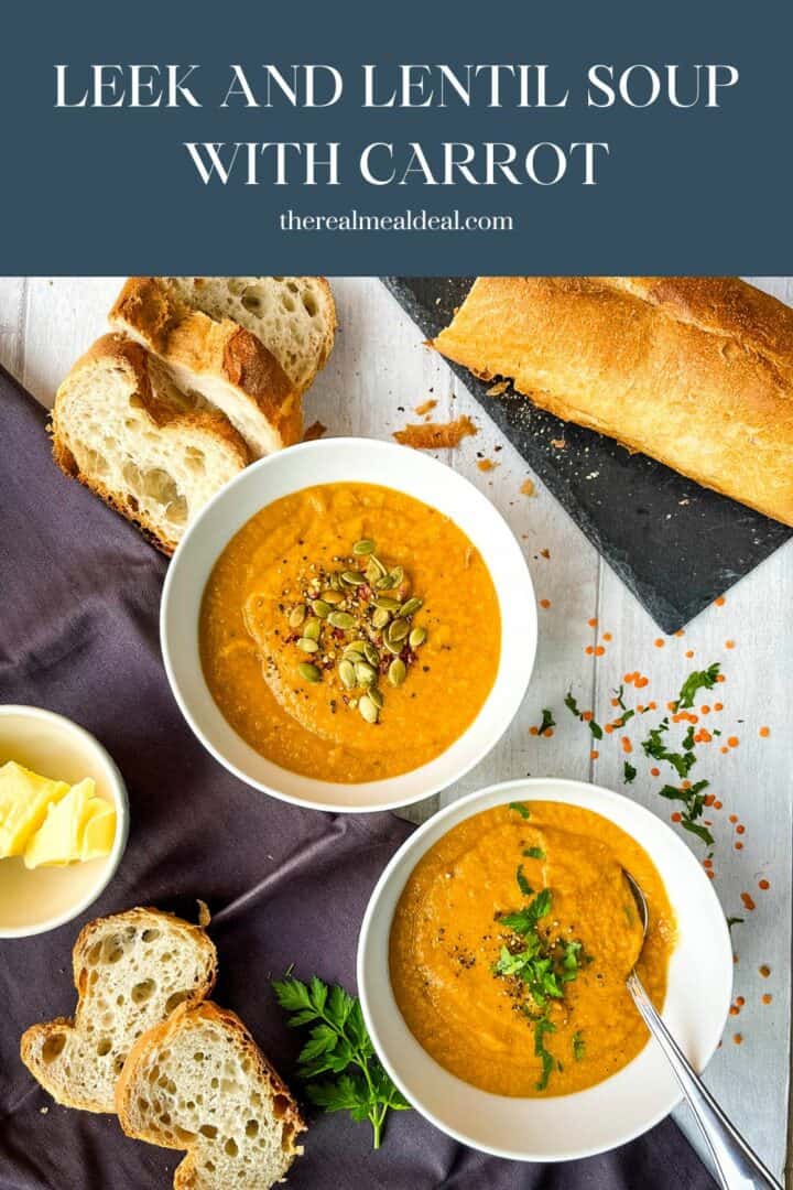 two bowls of red lentil soup served with baguette and topped with fresh parsley and pumpkin seeds.