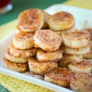 pan fried cinnamon bananas stacked on tray.