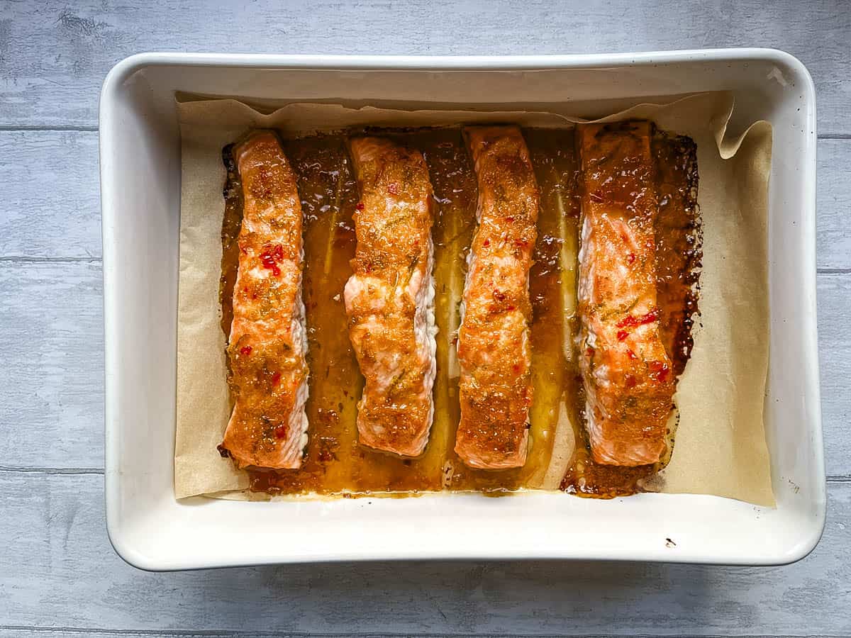 salmon fillets baked with marinade in oven proof dish.