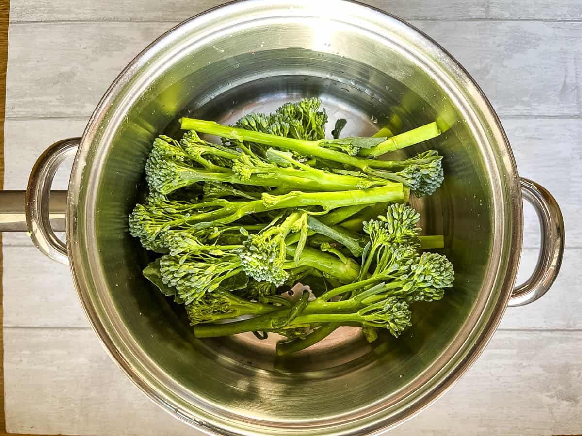 tenderstem broccoli steaming in pan.