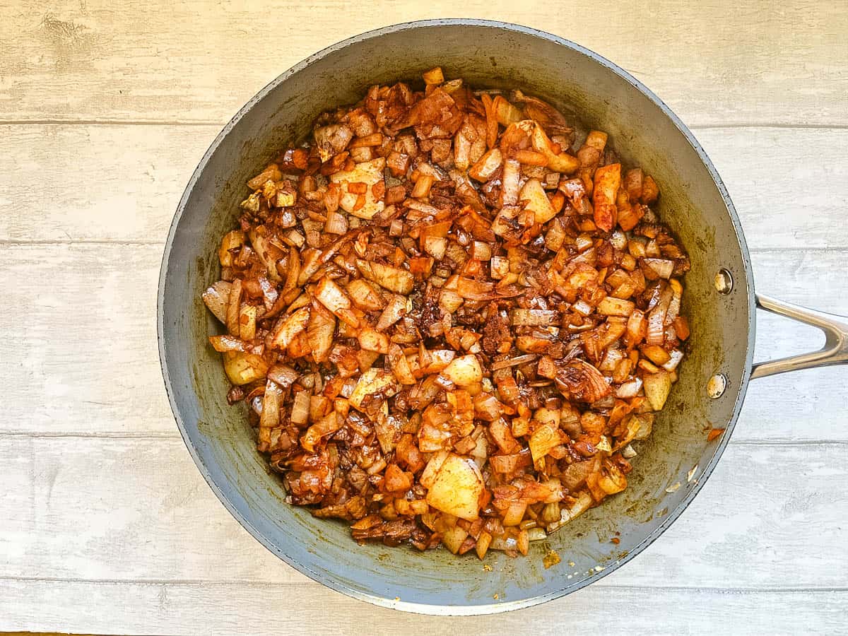 smoked paprika added to frying onions in pan.