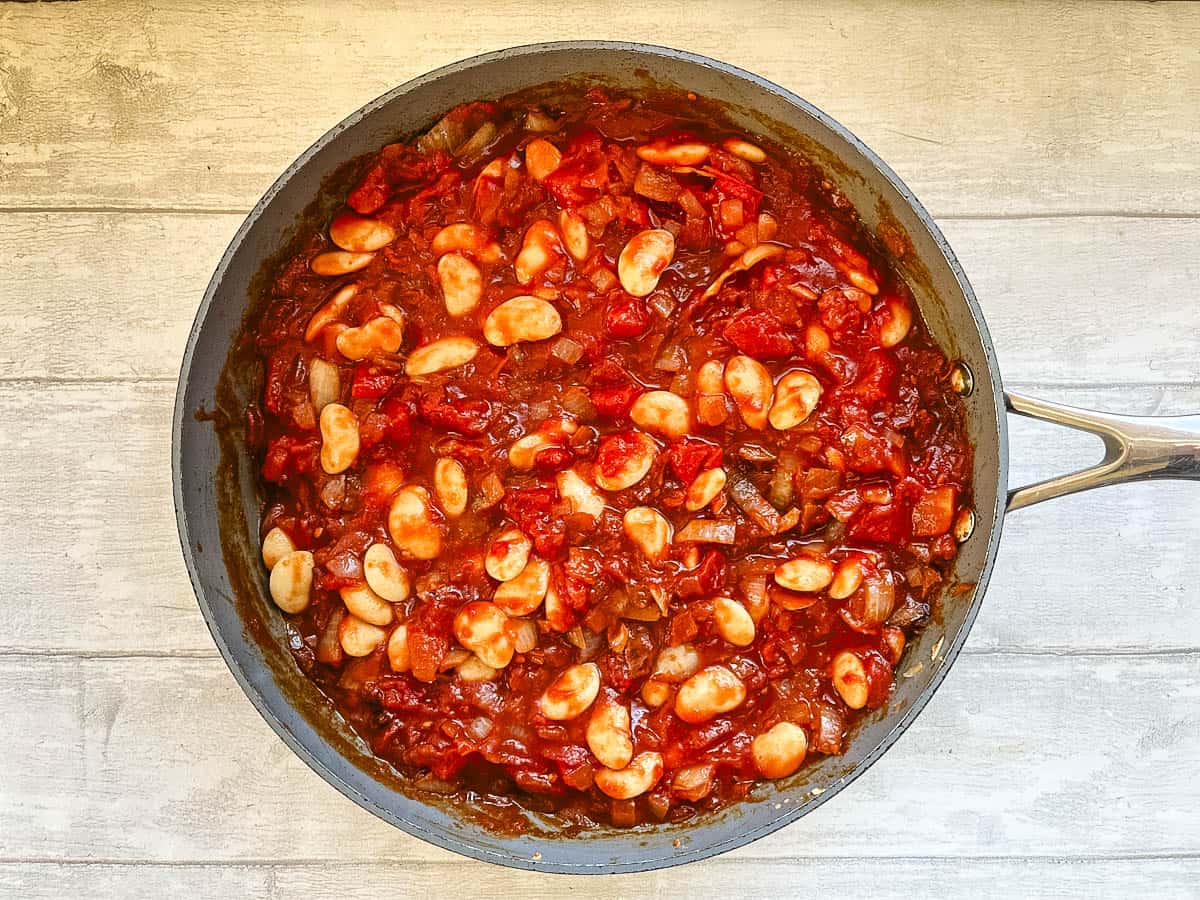 butterbeans chopped tomatoes and diced onions in pan.