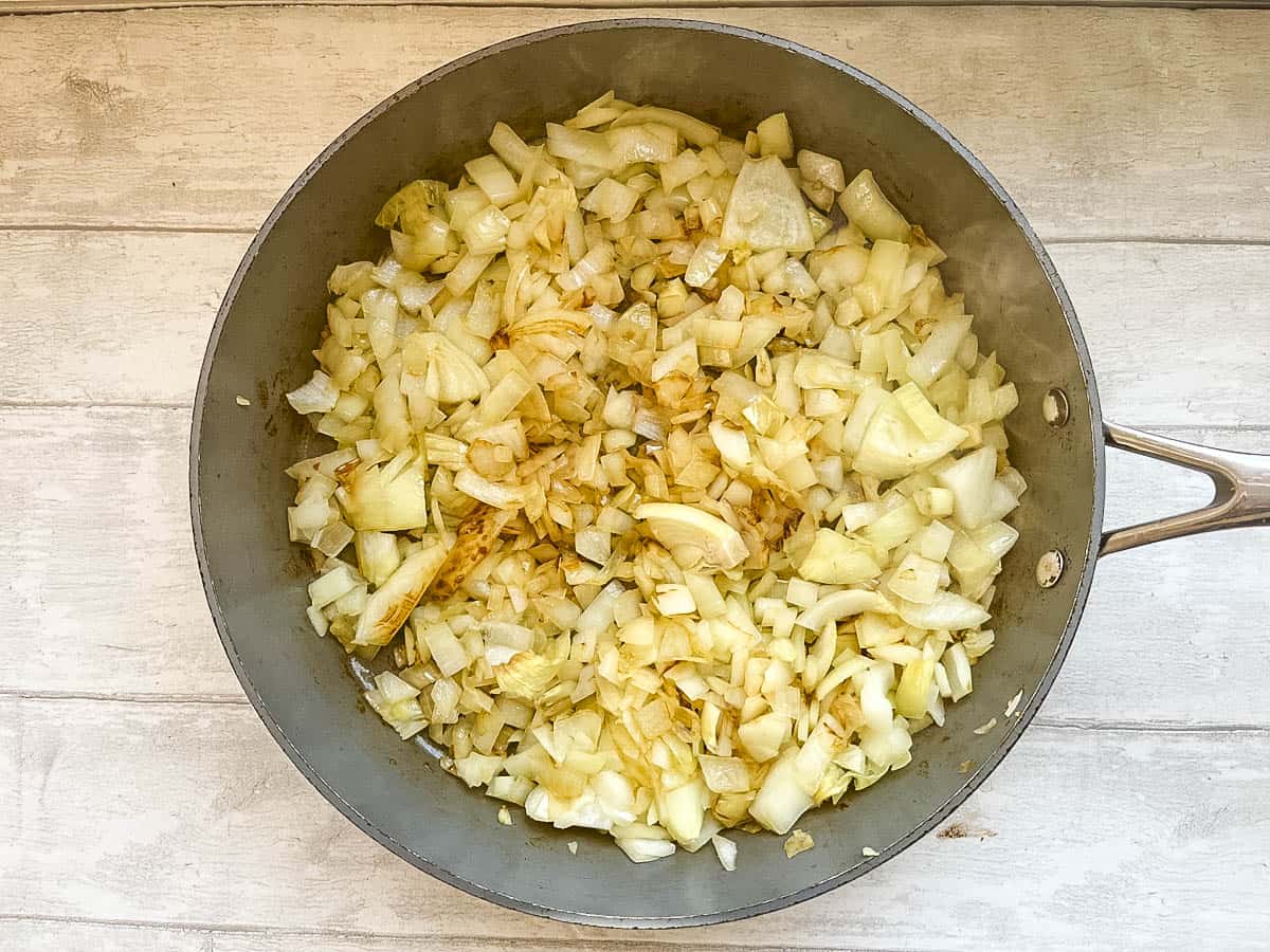 diced onions frying in pan.