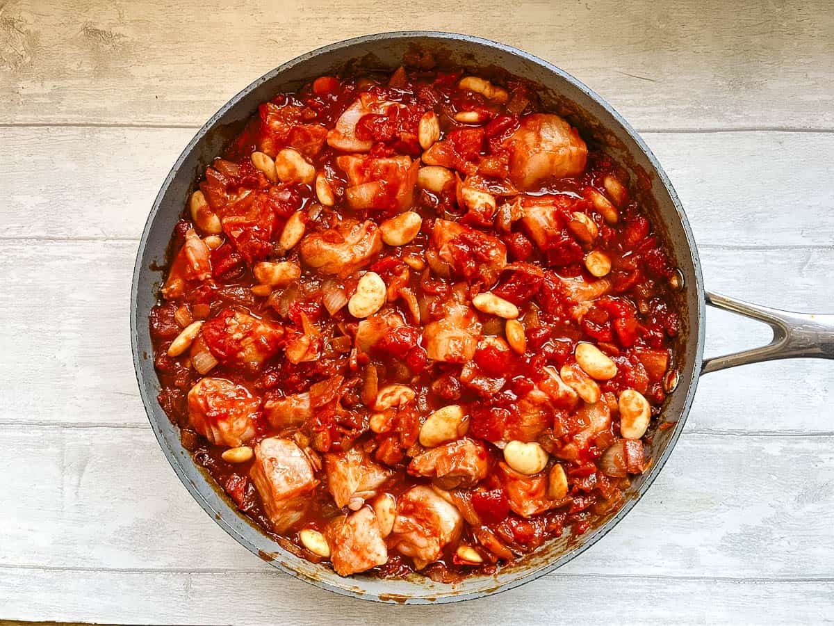 diced fish added to butterbeans, tomatoes, onions and smoked paprika in pan.