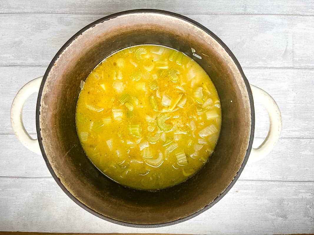 stock added to diced celery and onion in pan.