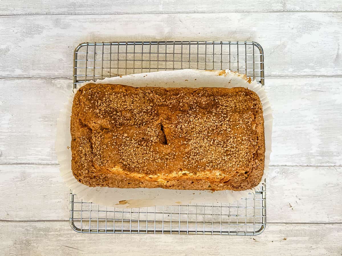 apple and pear loaf cake cooling on a rack.