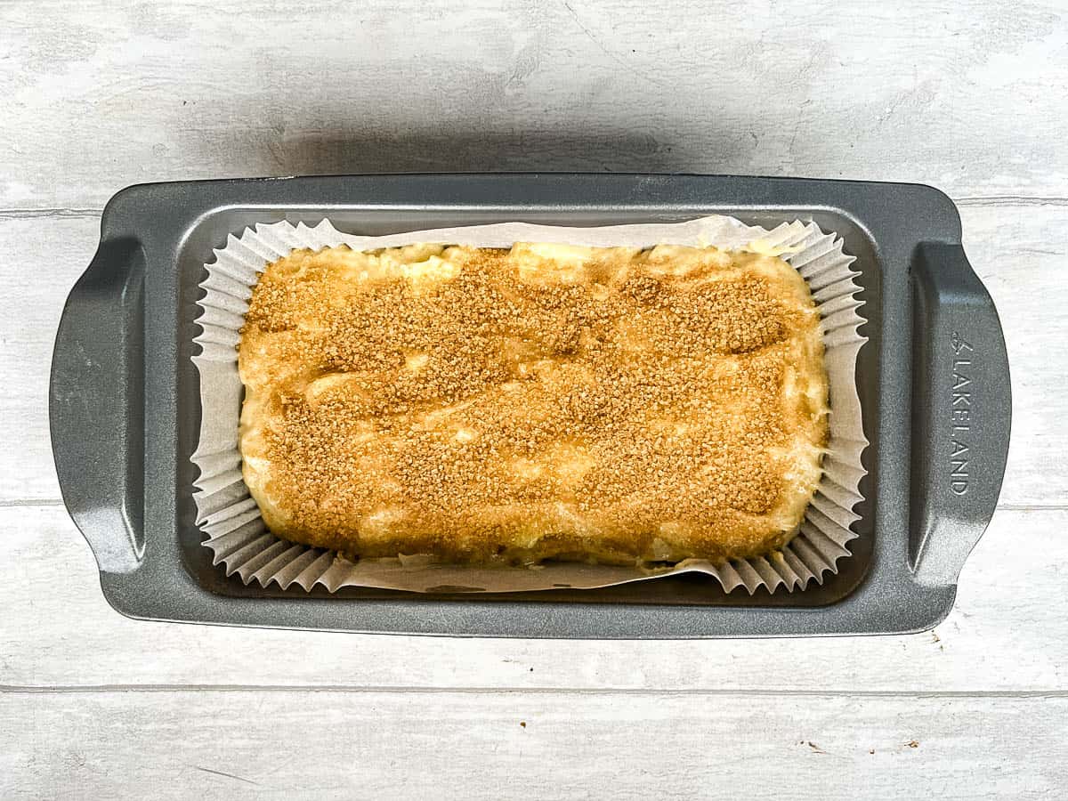 apple and pear loaf topped with demerara sugar and cinnamon.