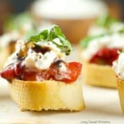 crostini topped with soft cheese and fresh tomatoes