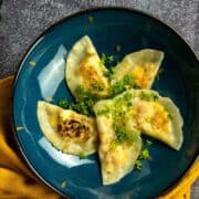plate with pierogies toipped with chopped parsley