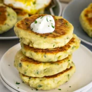 stack of bubble and squeak potato cakes topped with poached egg