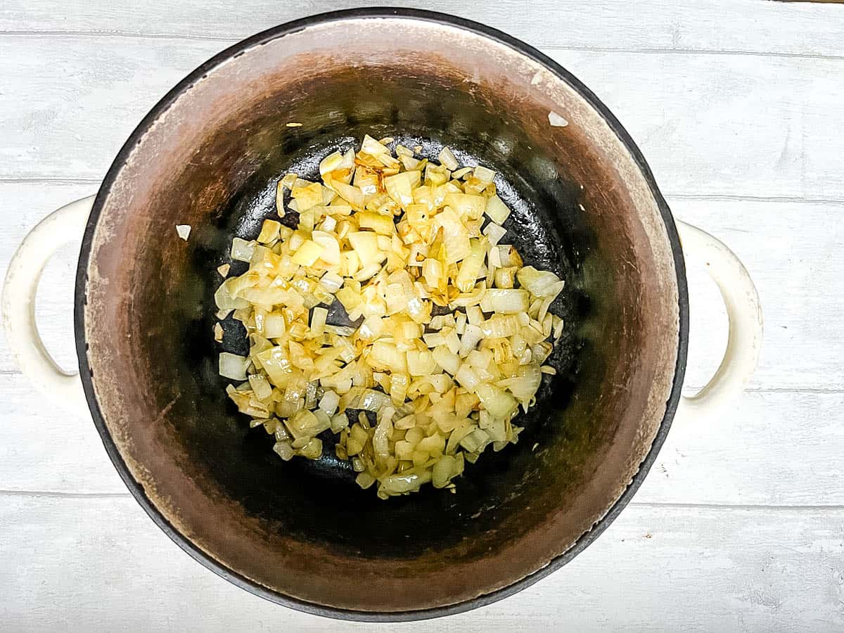 diced onion frying in pan.
