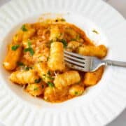mashed potato gnocchi with tomato sauce in a bowl.
