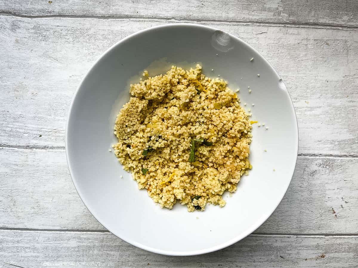 lemon couscous in bowl with fresh mint.